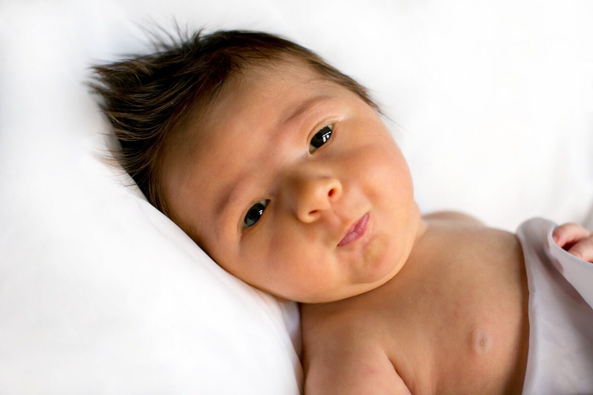 Cute baby engages with camera during portrait