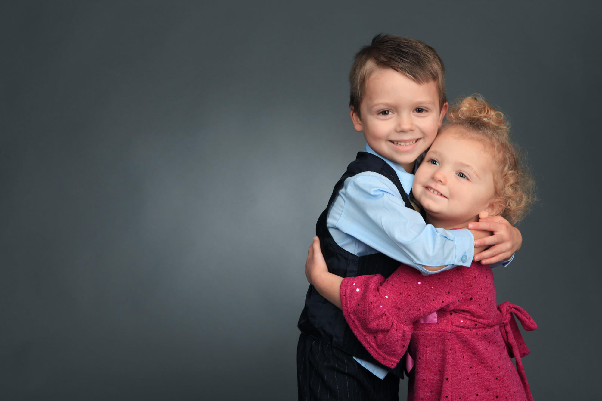 Siblings hugging during portrait session