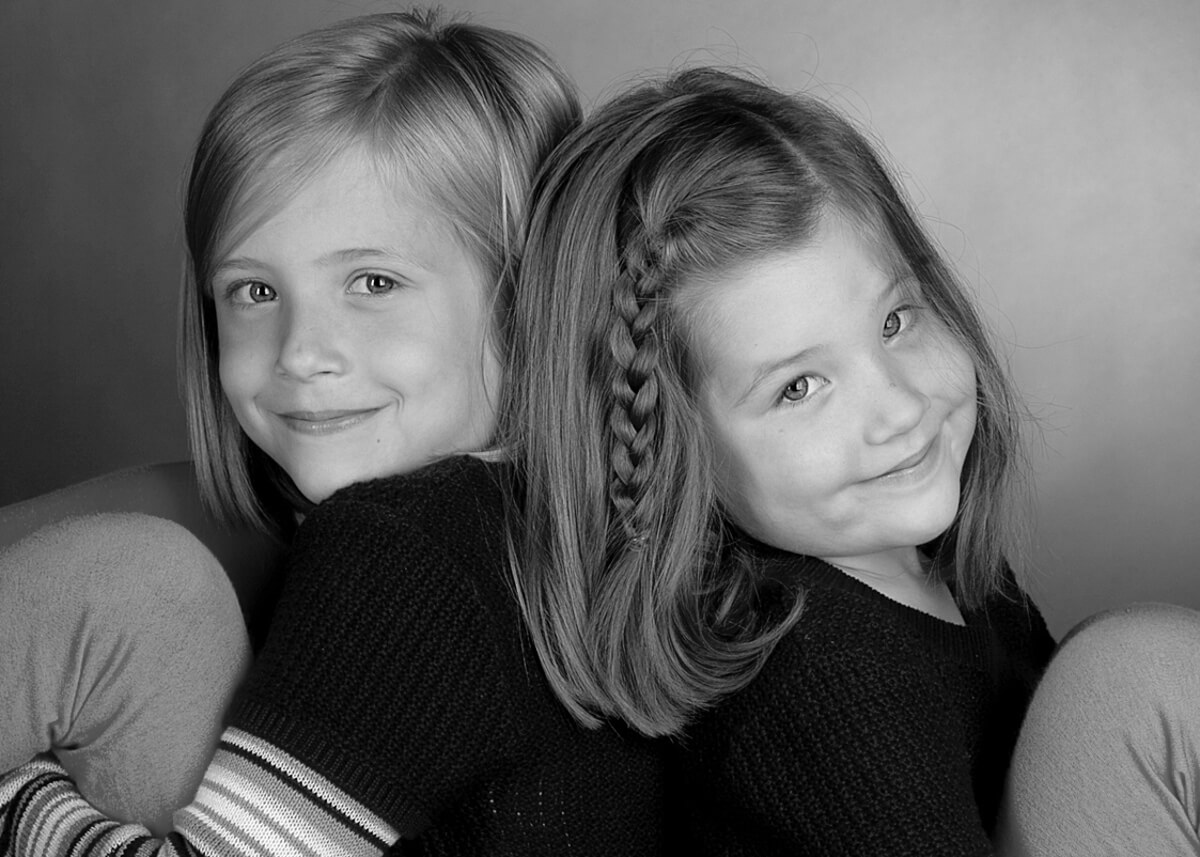 Sister pose for a fun black and white photo