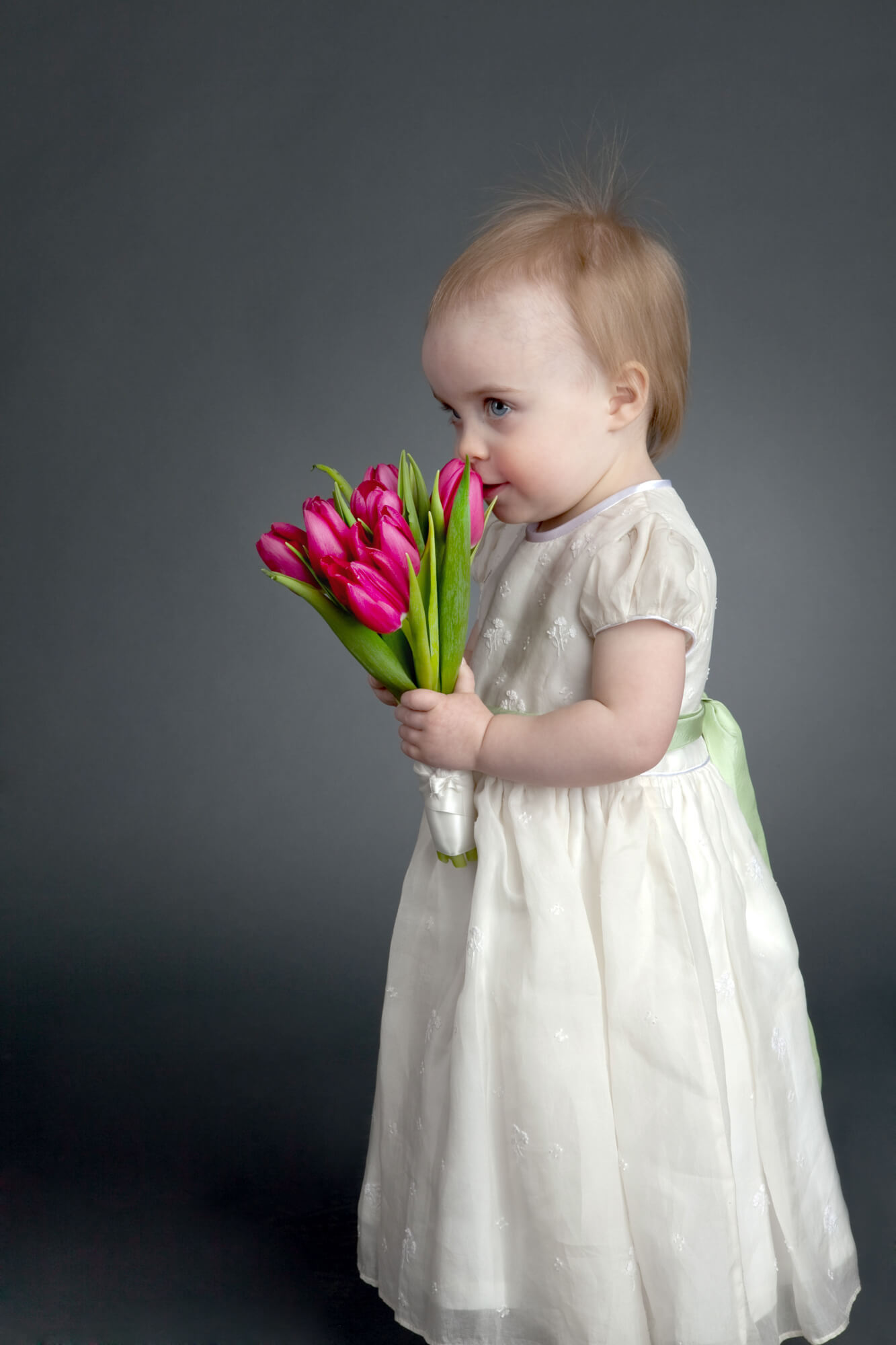 Young girl poses with tulips during portrait session