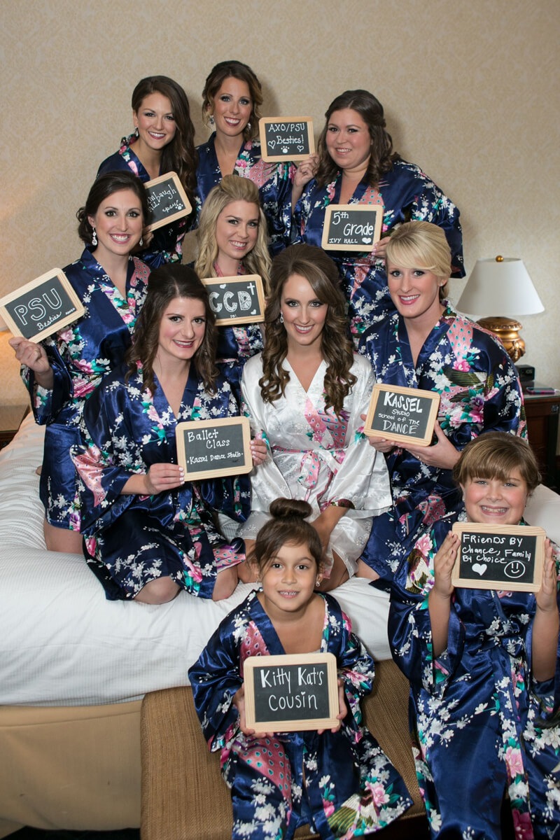 Bridesmaids with chalkboard and special robes