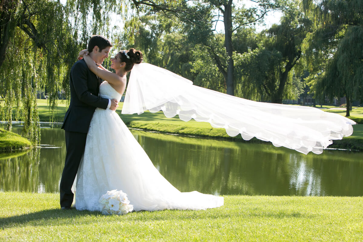 Veil blows during wedding portrait at country club