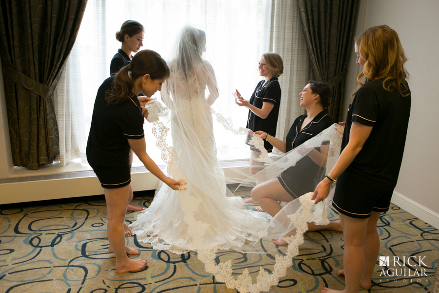 getting ready photos bridesmaids helping bride dress